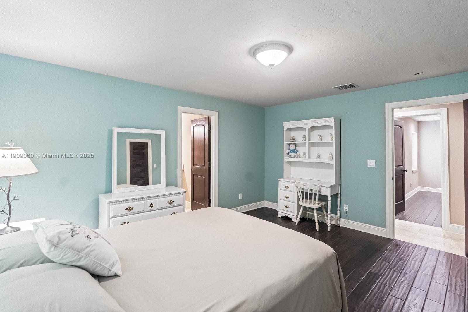 6500 Southwest 127th Street Pinecrest, FL 33156 - Photo 32 of 68 a bedroom with a bed and a table