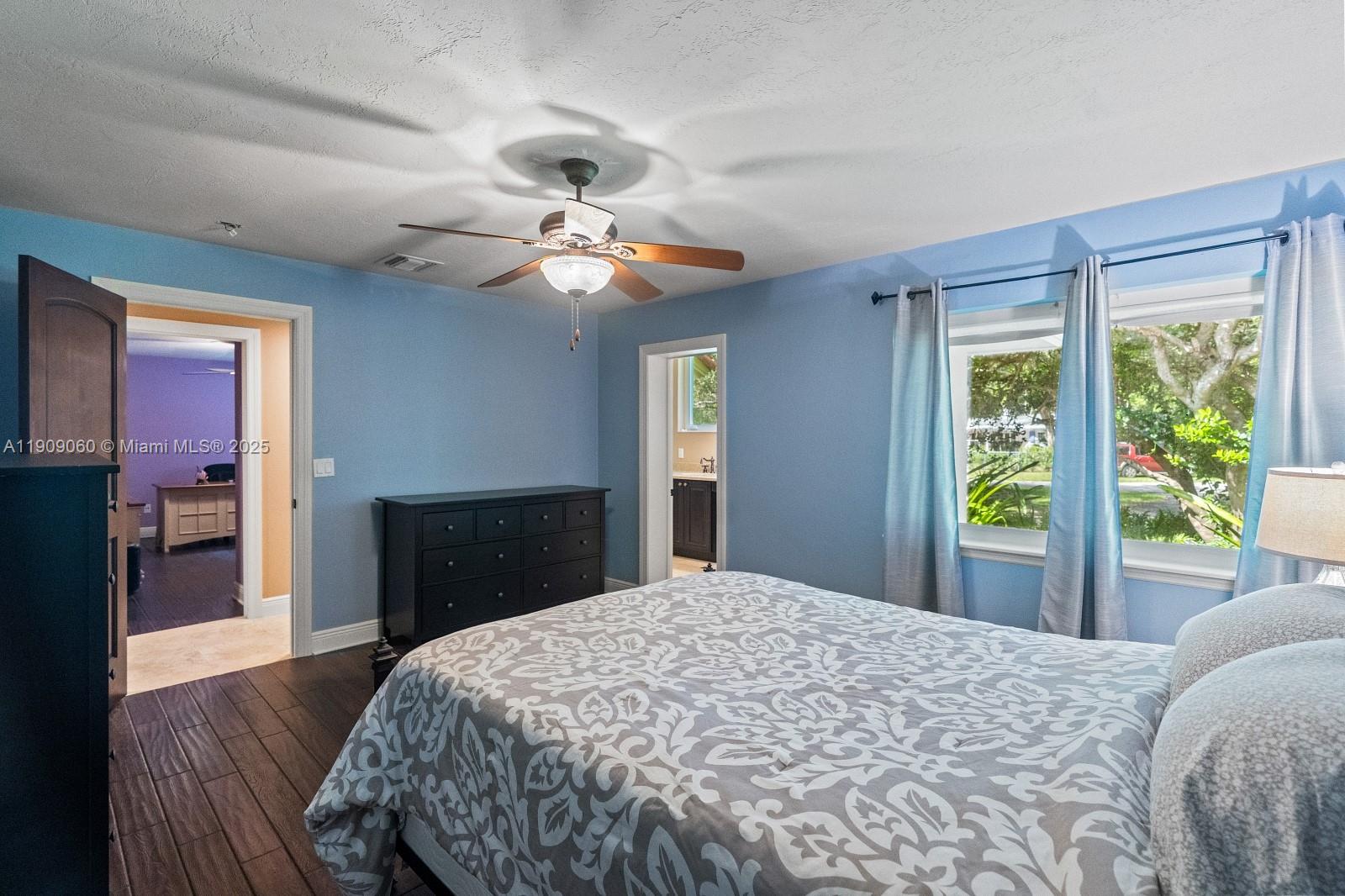 6500 Southwest 127th Street Pinecrest, FL 33156 - Photo 35 of 68 a bedroom with a bed ceiling fan and a window