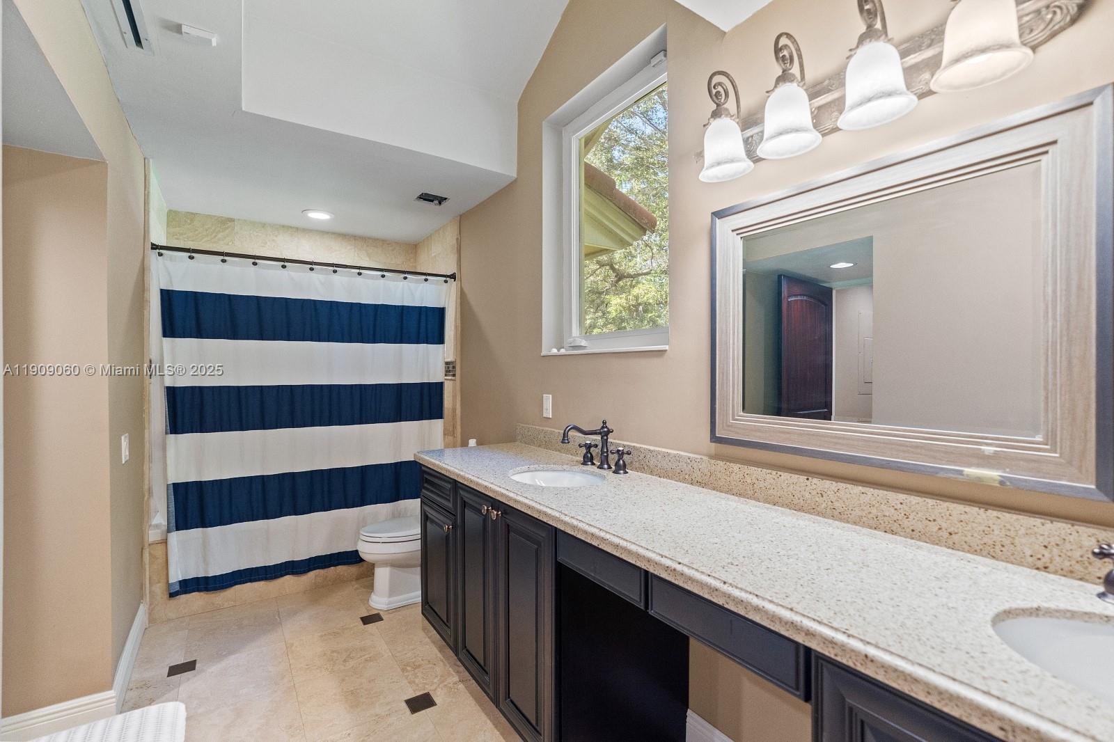 6500 Southwest 127th Street Pinecrest, FL 33156 - Photo 36 of 68 a bathroom with a sink and a mirror