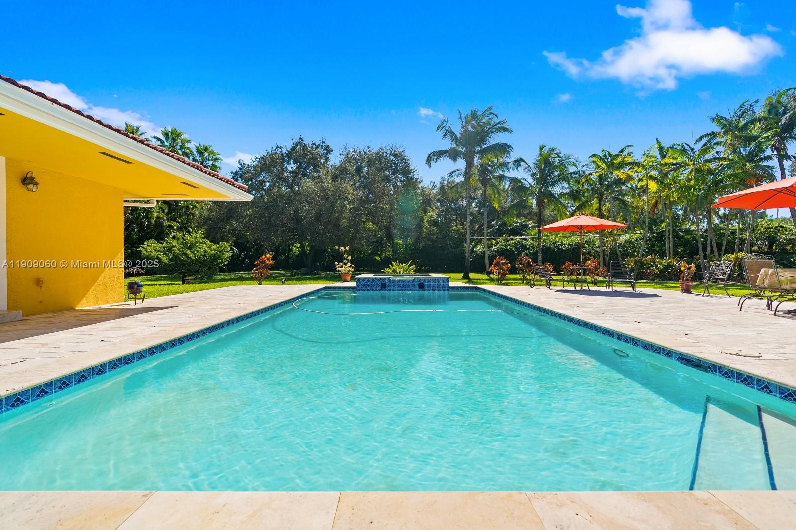 6500 Southwest 127th Street Pinecrest, FL 33156 - Photo 46 of 68 a view of a swimming pool with an outdoor seating and a yard