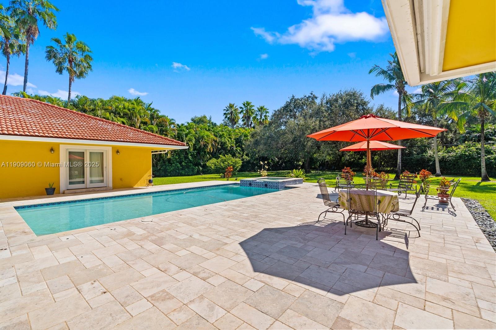 6500 Southwest 127th Street Pinecrest, FL 33156 - Photo 47 of 68 a view of a patio with a table and chairs under an umbrella