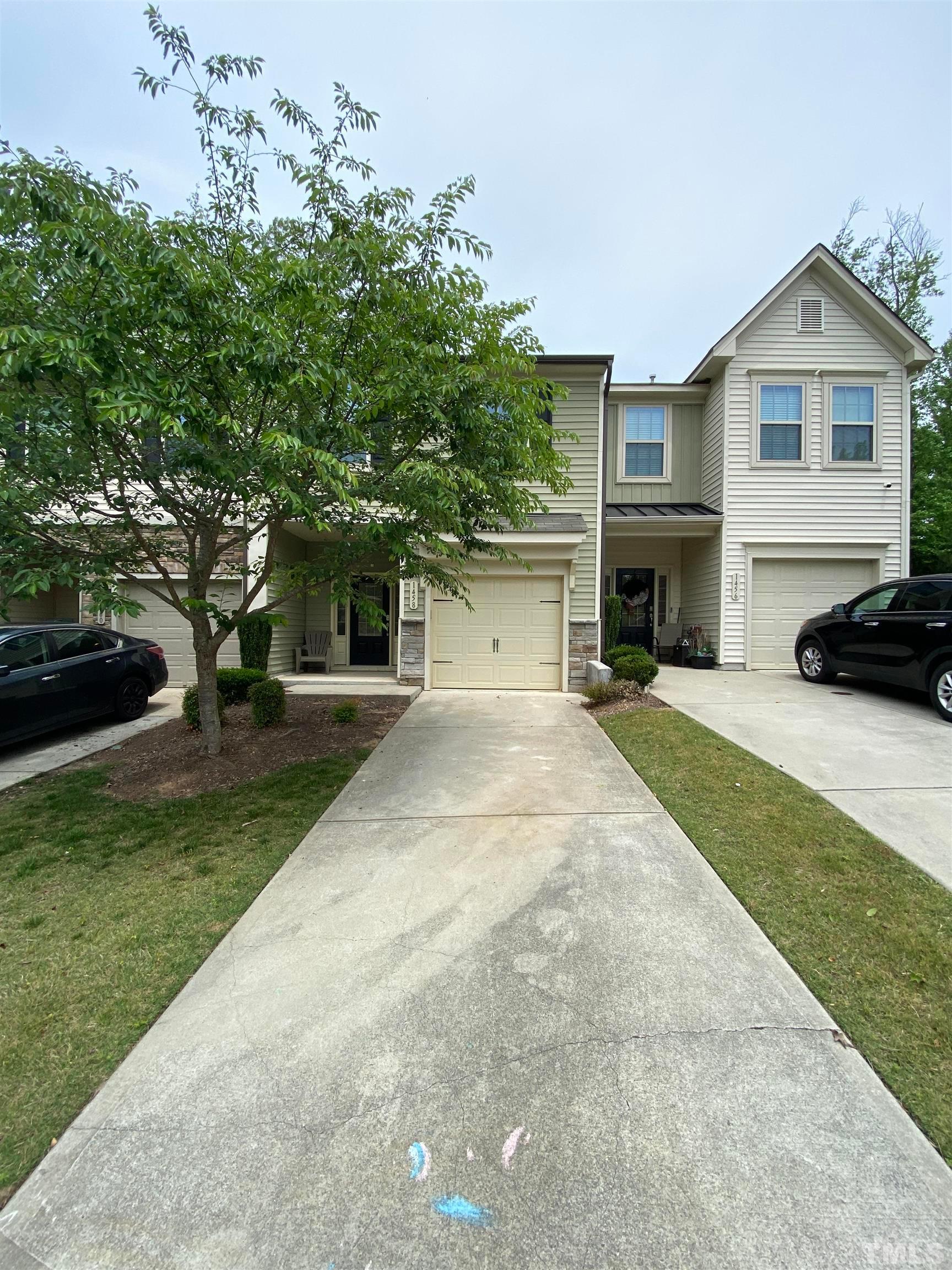 1458 Chatuga Way Wake Forest, NC 27587 - Photo 4 of 25 a front view of a house with a yard and garage