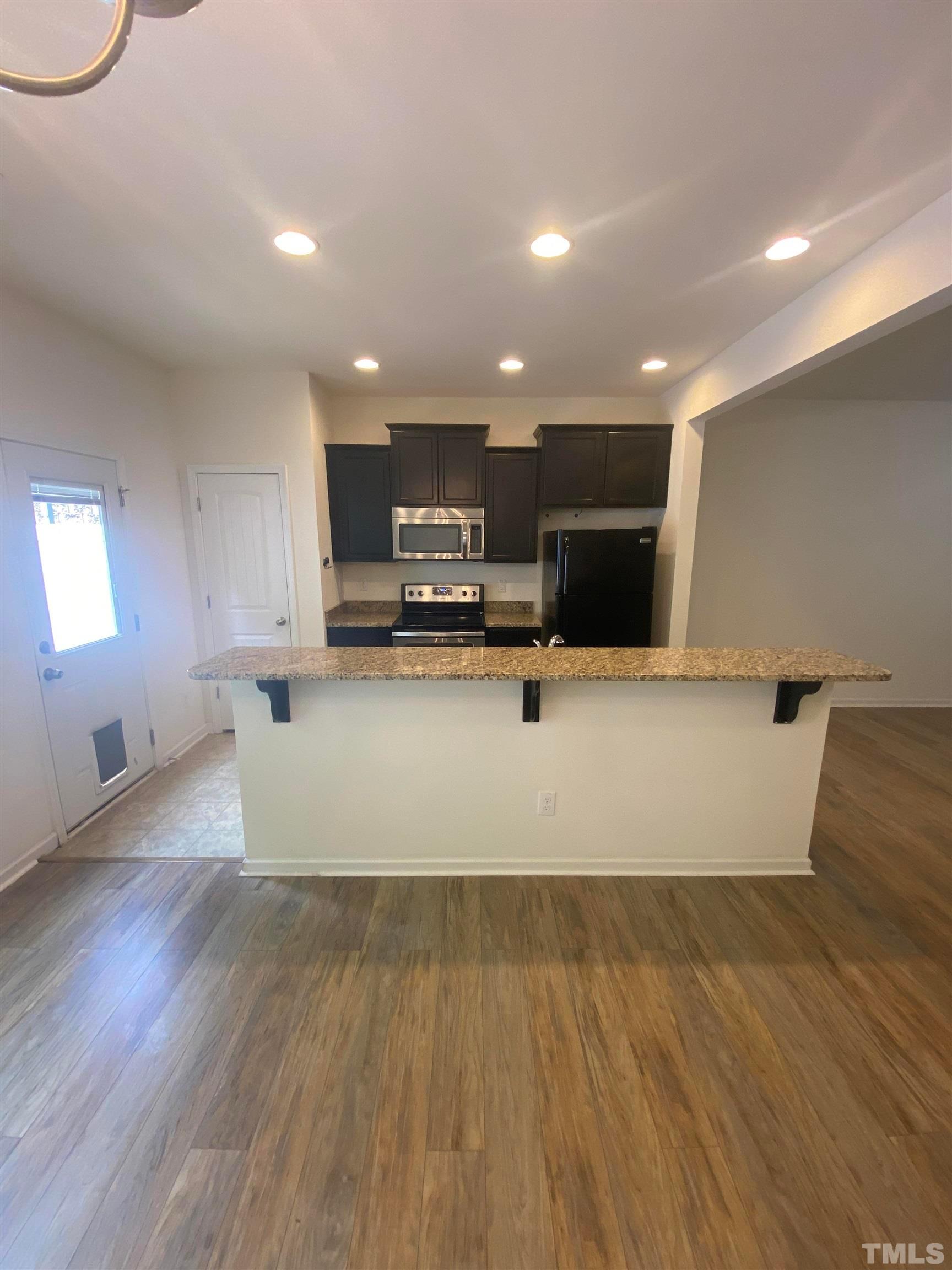 1458 Chatuga Way Wake Forest, NC 27587 - Photo 5 of 25 a view of kitchen with microwave and cabinets