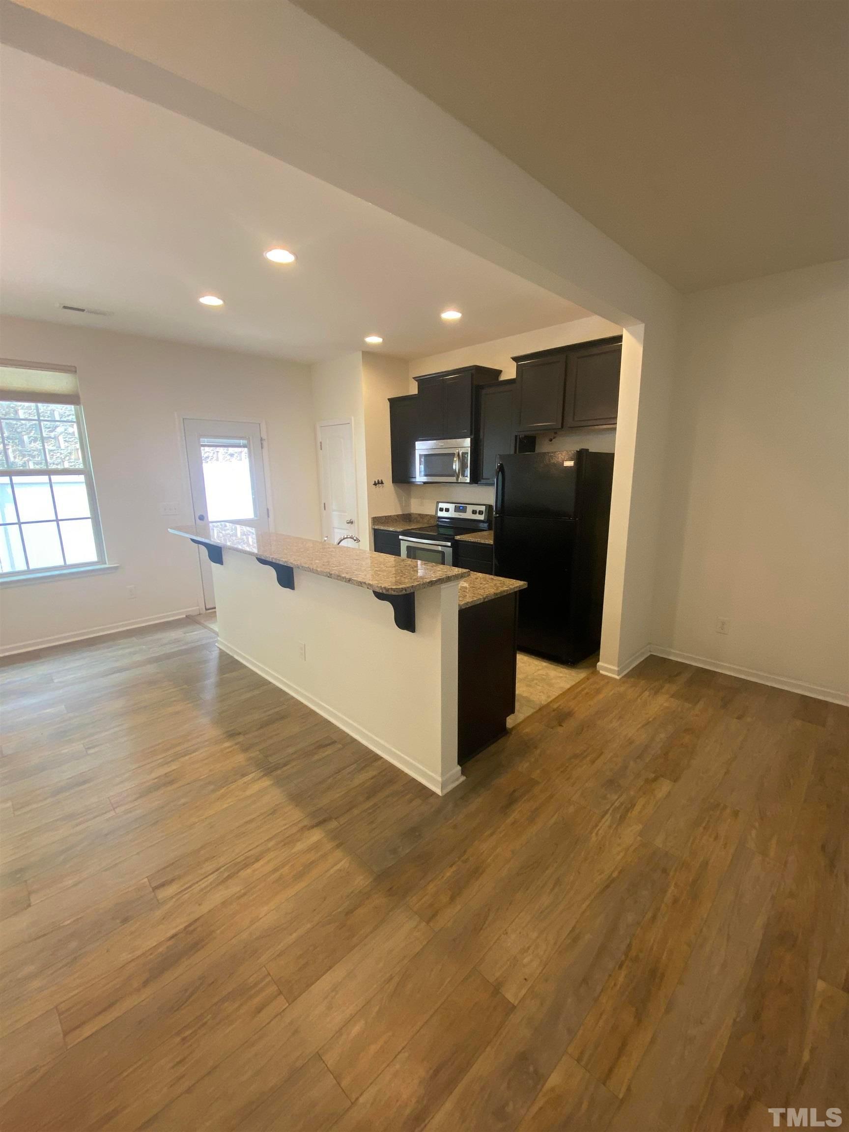 1458 Chatuga Way Wake Forest, NC 27587 - Photo 6 of 25 a view of kitchen with kitchen island wooden floor and center island