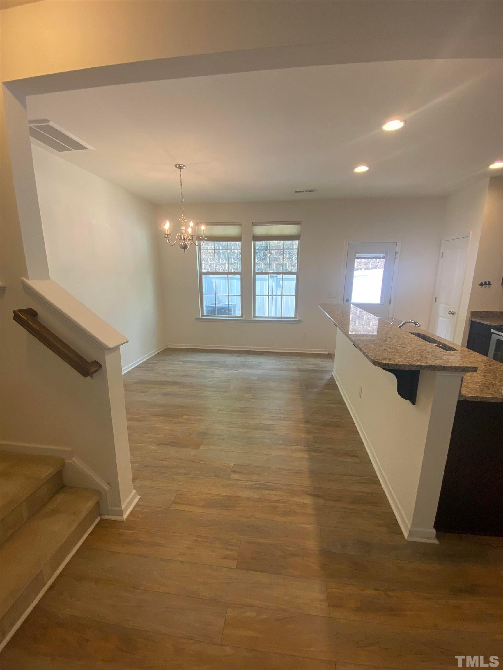 1458 Chatuga Way Wake Forest, NC 27587 - Photo 7 of 25 a view of an empty room with wooden floor and a window