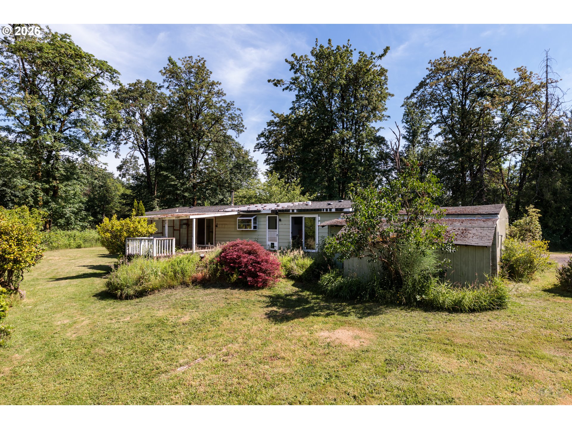 66971 Maplecrest Road Deer Island, OR 97054 - Photo 17 of 24 a view of a backyard with potted plants and large trees