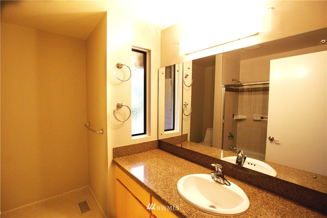 4601 Northeast 24th Street Renton, WA 98059 - Photo 12 of 25 a bathroom with a granite countertop sink and a mirror