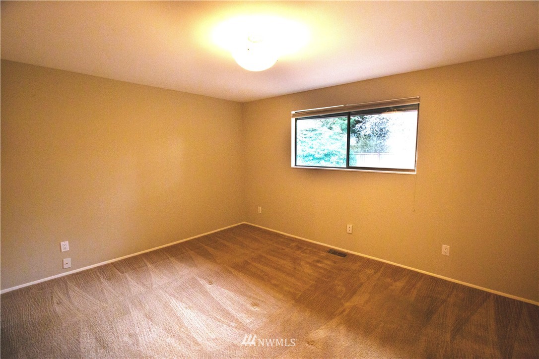 4601 Northeast 24th Street Renton, WA 98059 - Photo 13 of 25 an empty room with a window and painting on the wall
