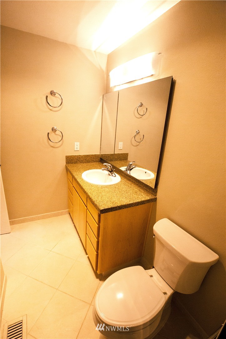 4601 Northeast 24th Street Renton, WA 98059 - Photo 14 of 25 a bathroom with a toilet a sink and mirror