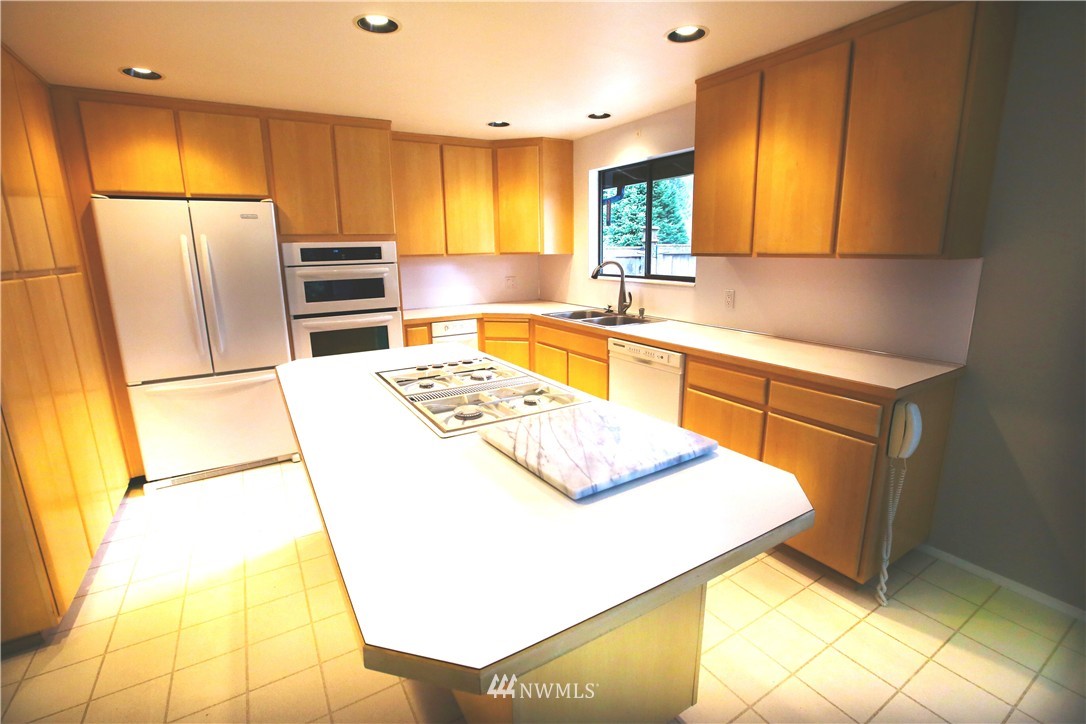 4601 Northeast 24th Street Renton, WA 98059 - Photo 7 of 25 a kitchen with stainless steel appliances a stove a sink and a refrigerator