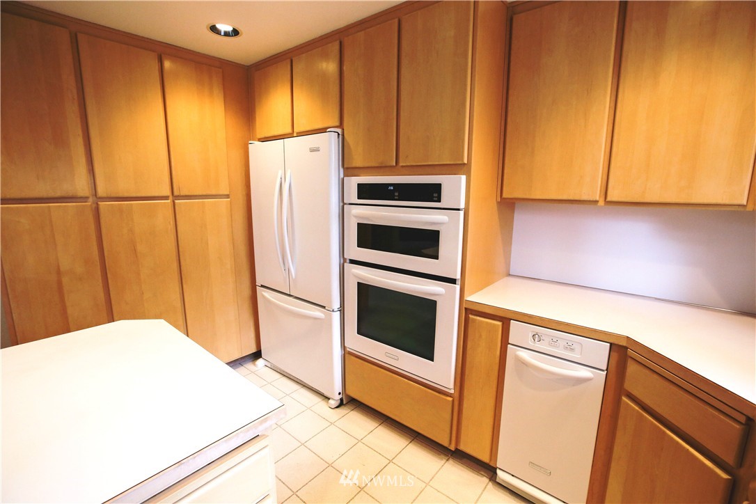 4601 Northeast 24th Street Renton, WA 98059 - Photo 8 of 25 a kitchen with stainless steel appliances a refrigerator and a stove