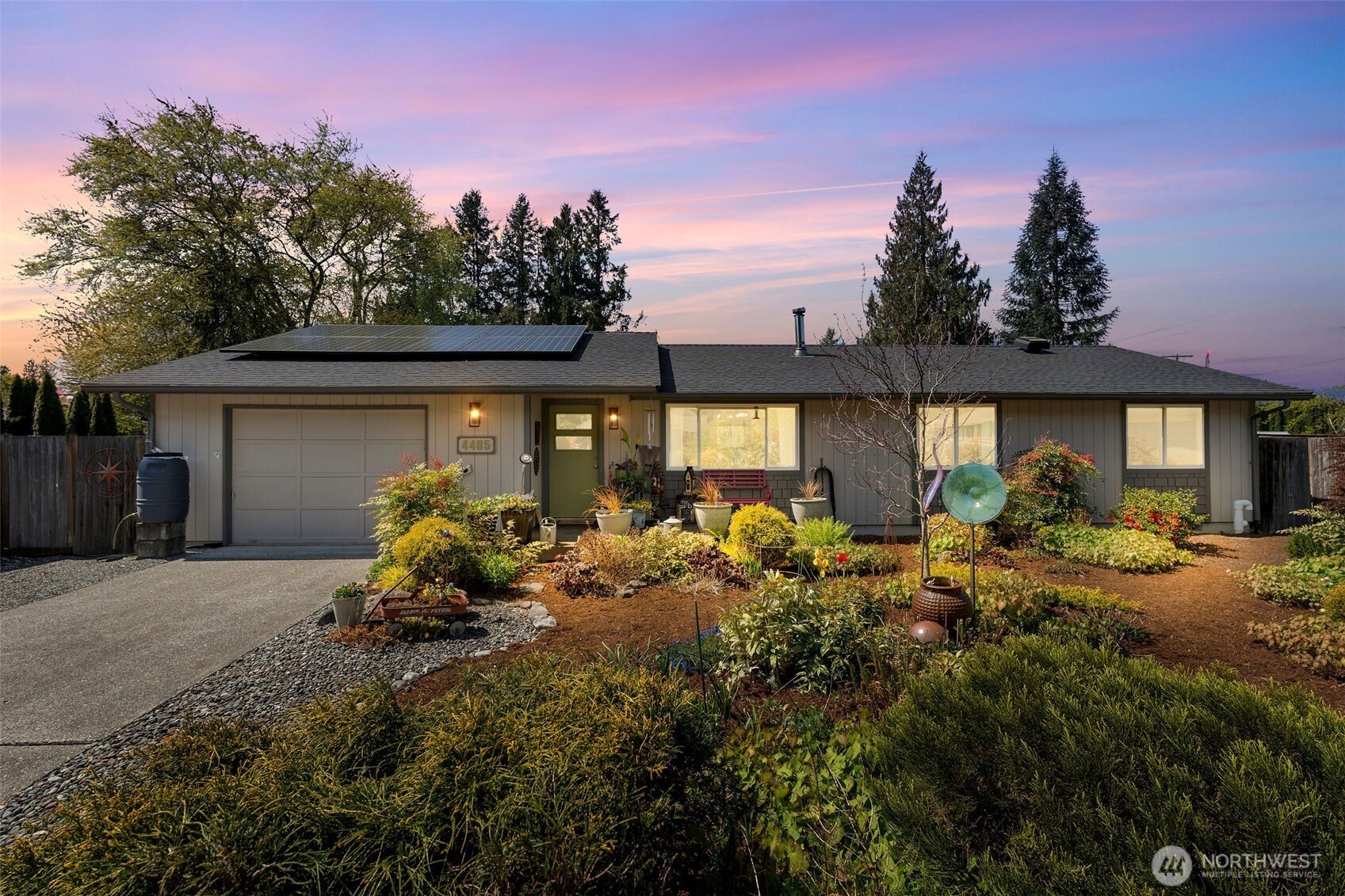 a view of a house with backyard and sitting area
