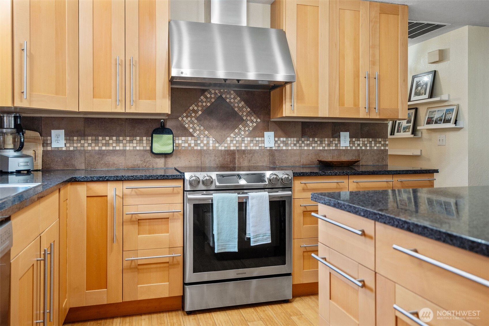 4405 Royal Court Carnation, WA 98014 - Photo 11 of 34 a kitchen with stainless steel appliances granite countertop a stove and a white cabinets