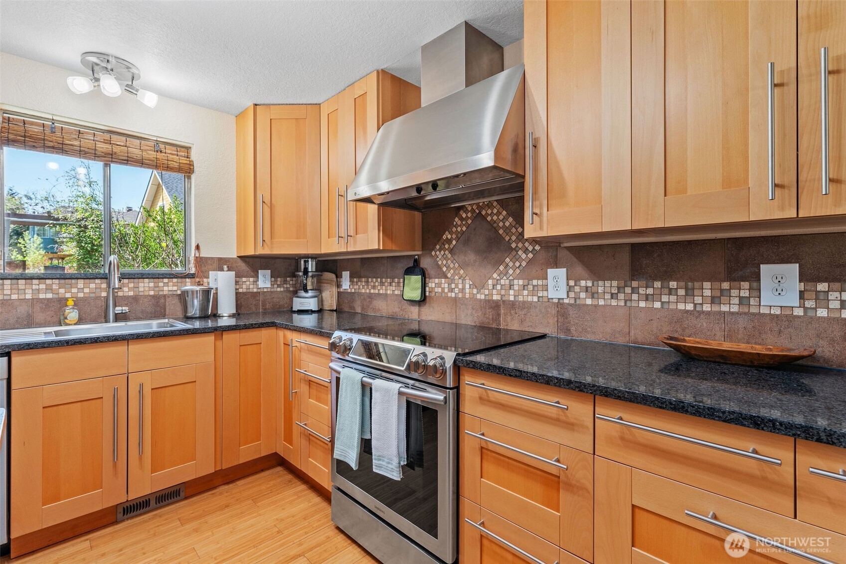 4405 Royal Court Carnation, WA 98014 - Photo 12 of 34 a kitchen with stainless steel appliances granite countertop a sink a stove and cabinets