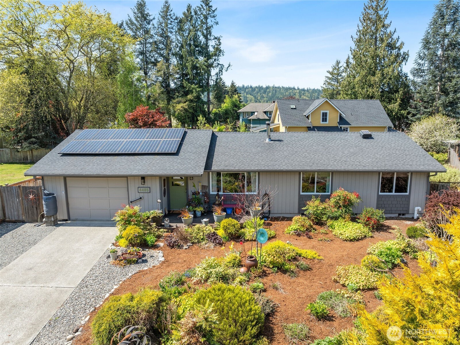 4405 Royal Court Carnation, WA 98014 - Photo 3 of 34 a front view of a house with a yard and a garden