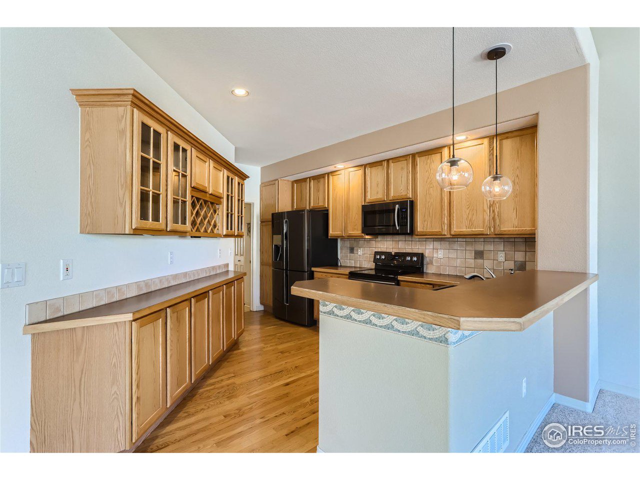 4159 Da Vinci Drive Longmont, CO 80503 - Photo 12 of 32 a kitchen with stainless steel appliances granite countertop a sink stove and refrigerator