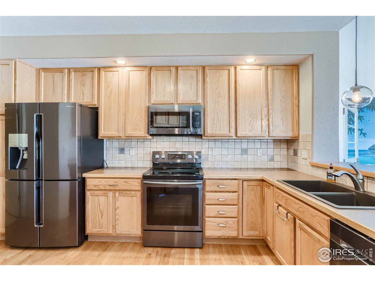 4159 Da Vinci Drive Longmont, CO 80503 - Photo 13 of 32 a kitchen with a refrigerator stove and sink