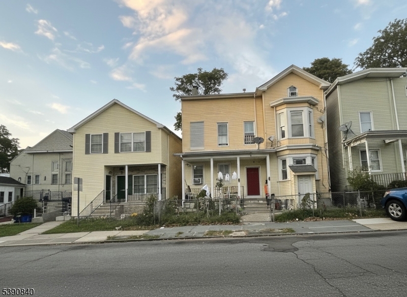 377-379 Ellison Street Paterson, NJ 07501 - Photo 14 of 28 a front view of a house with a yard