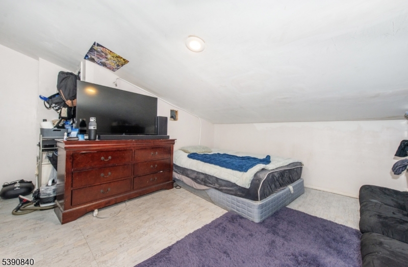 377-379 Ellison Street Paterson, NJ 07501 - Photo 16 of 28 a living room with furniture and a flat screen tv