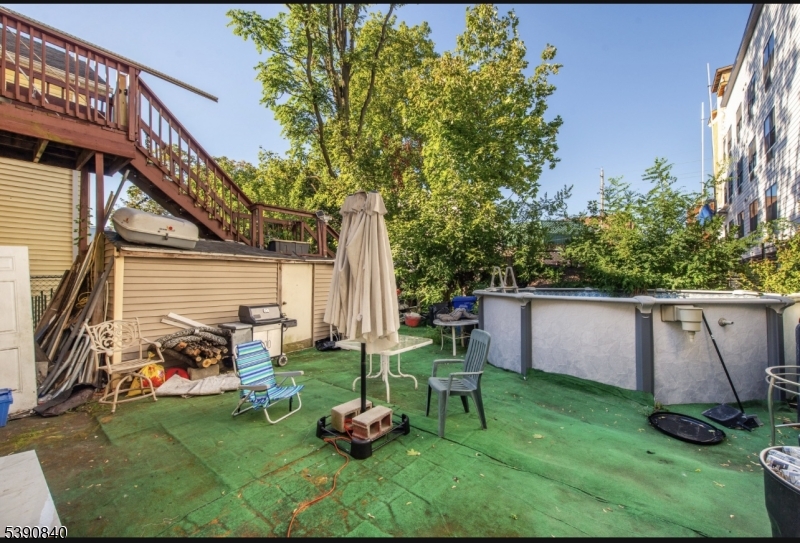 377-379 Ellison Street Paterson, NJ 07501 - Photo 18 of 28 a view of a chair and tables in the back yard of the house