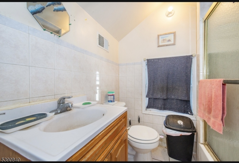 377-379 Ellison Street Paterson, NJ 07501 - Photo 20 of 28 a bathroom with a sink toilet and shower