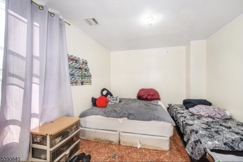 377-379 Ellison Street Paterson, NJ 07501 - Photo 24 of 28 a bedroom with a bed and a window