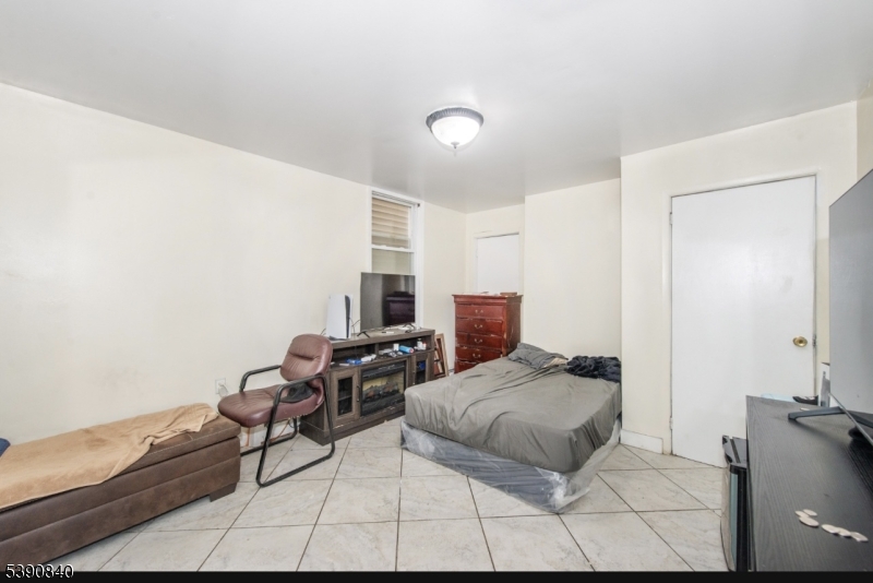 377-379 Ellison Street Paterson, NJ 07501 - Photo 26 of 28 a bedroom with furniture and a lamp