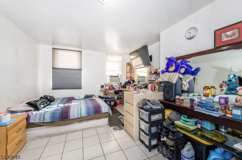 377-379 Ellison Street Paterson, NJ 07501 - Photo 27 of 28 a bed room with furniture and a window