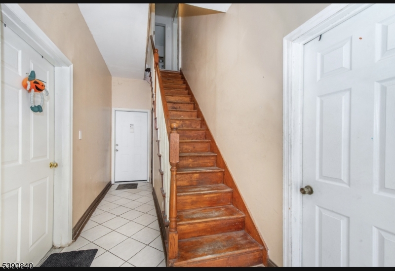 377-379 Ellison Street Paterson, NJ 07501 - Photo 28 of 28 a view of a hallway with wooden floor and entryway