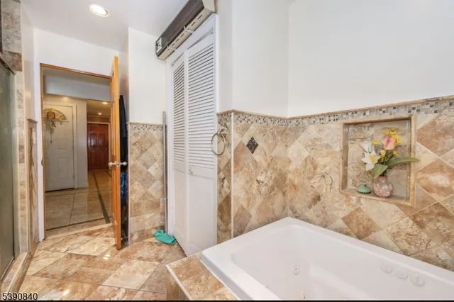 a bathroom with a bathtub and shower