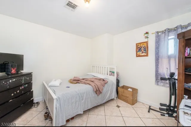 a bed room with a bed and a television