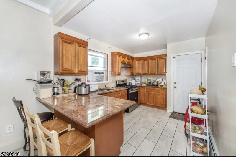 377-379 Ellison Street Paterson, NJ 07501 - Photo 7 of 28 a large kitchen with a table and chairs