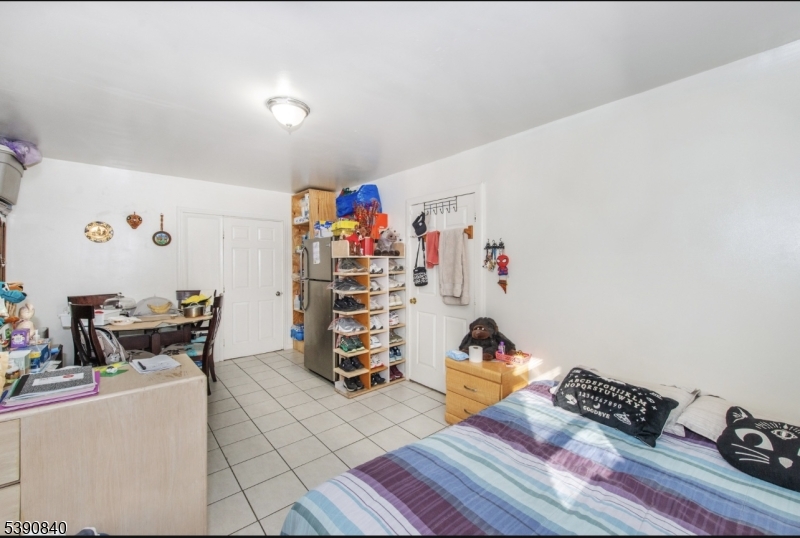 377-379 Ellison Street Paterson, NJ 07501 - Photo 10 of 28 a bedroom with furniture and a bed