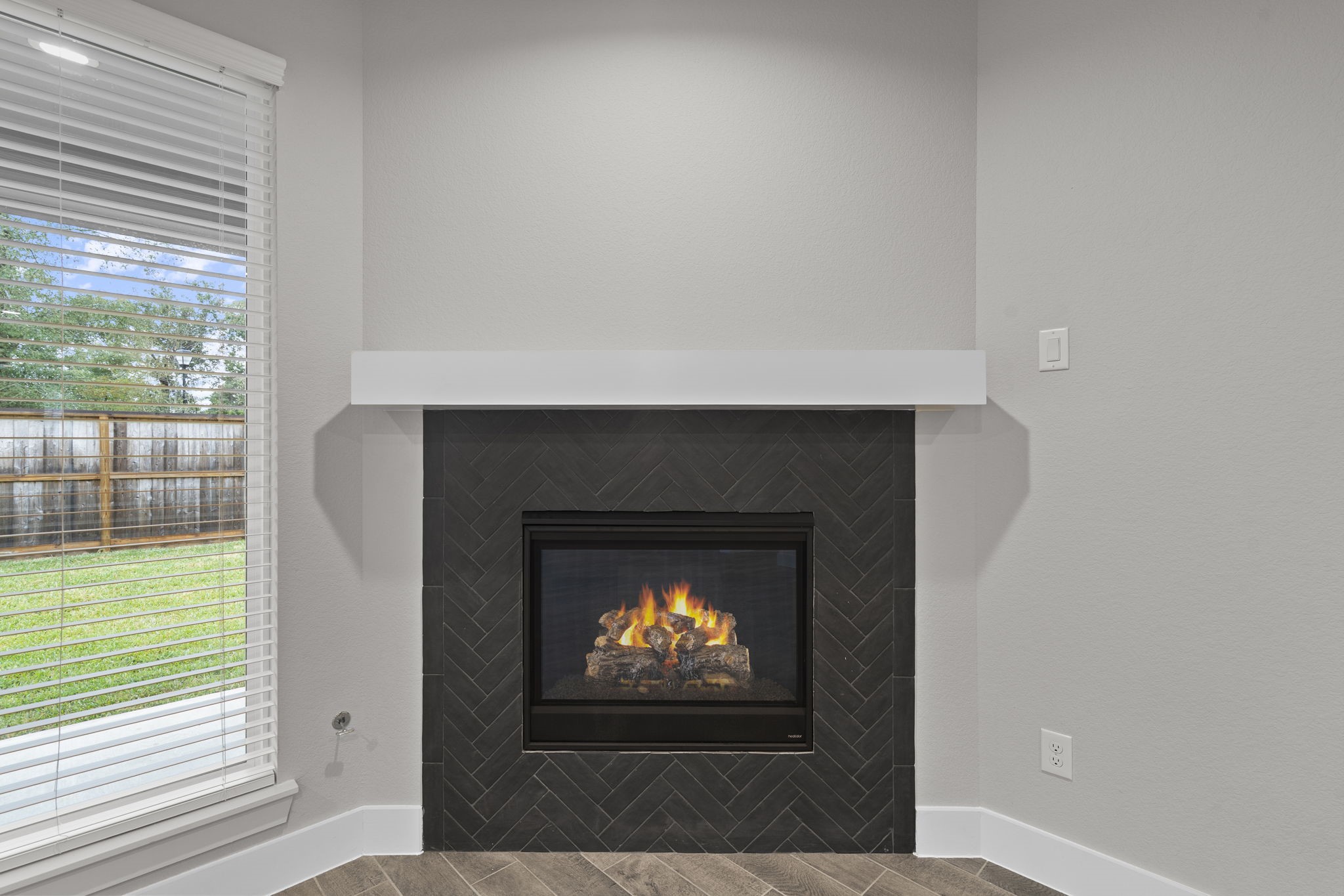 2116 Golden Spruce Court Conroe, TX 77301 - Photo 11 of 28 a living room with a fireplace and a flat screen tv