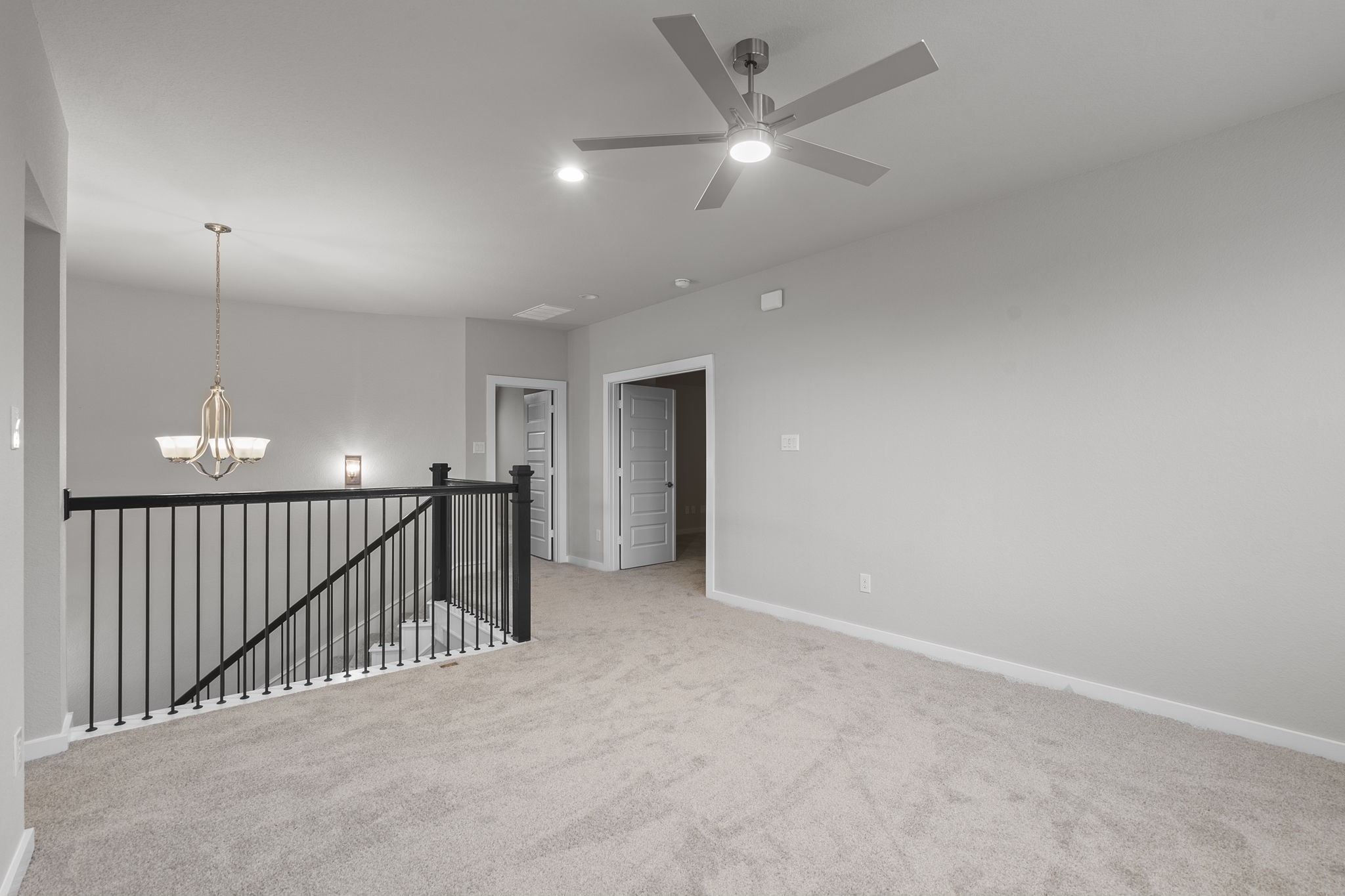 2116 Golden Spruce Court Conroe, TX 77301 - Photo 12 of 28 an empty room with staircase and fan