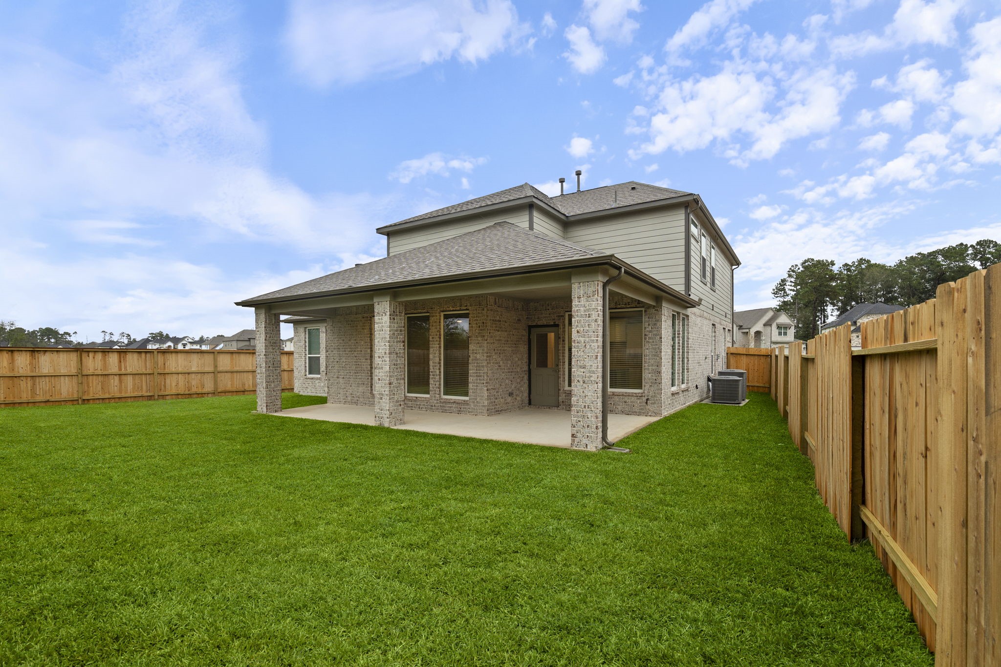 2116 Golden Spruce Court Conroe, TX 77301 - Photo 22 of 28 a view of a house with backyard porch and garden