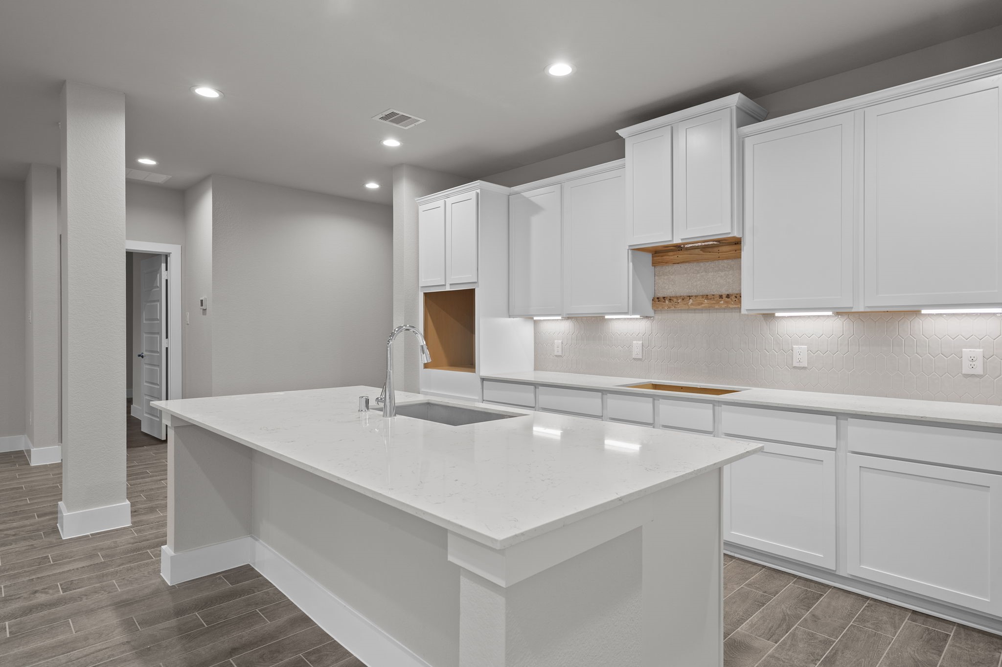 2116 Golden Spruce Court Conroe, TX 77301 - Photo 4 of 28 a kitchen with kitchen island a sink appliances and cabinets