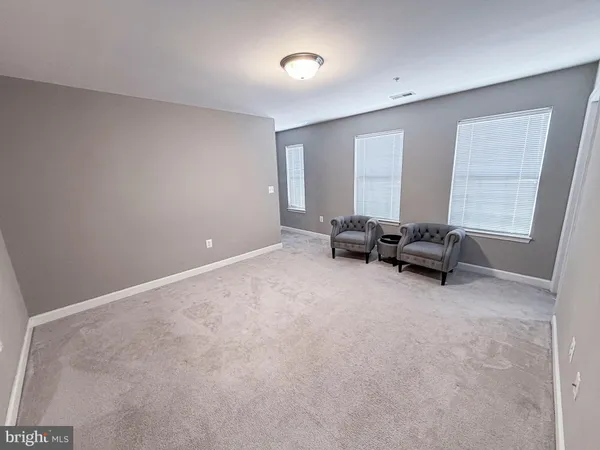 a view of a livingroom with furniture and a window