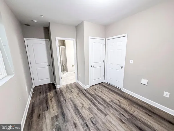 a view of a room with wooden floor and a sink