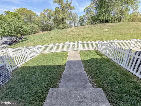 a view of a pathway with a garden