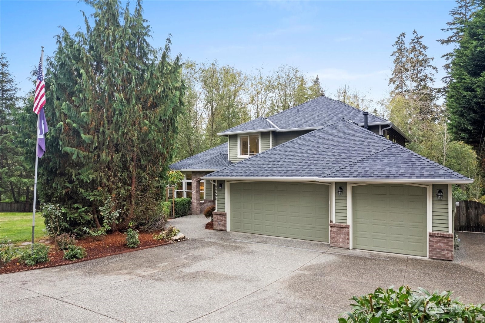 22920 53rd Avenue Southeast Bothell, WA 98021 - Photo 1 of 40 a front view of a house with a garden and tree