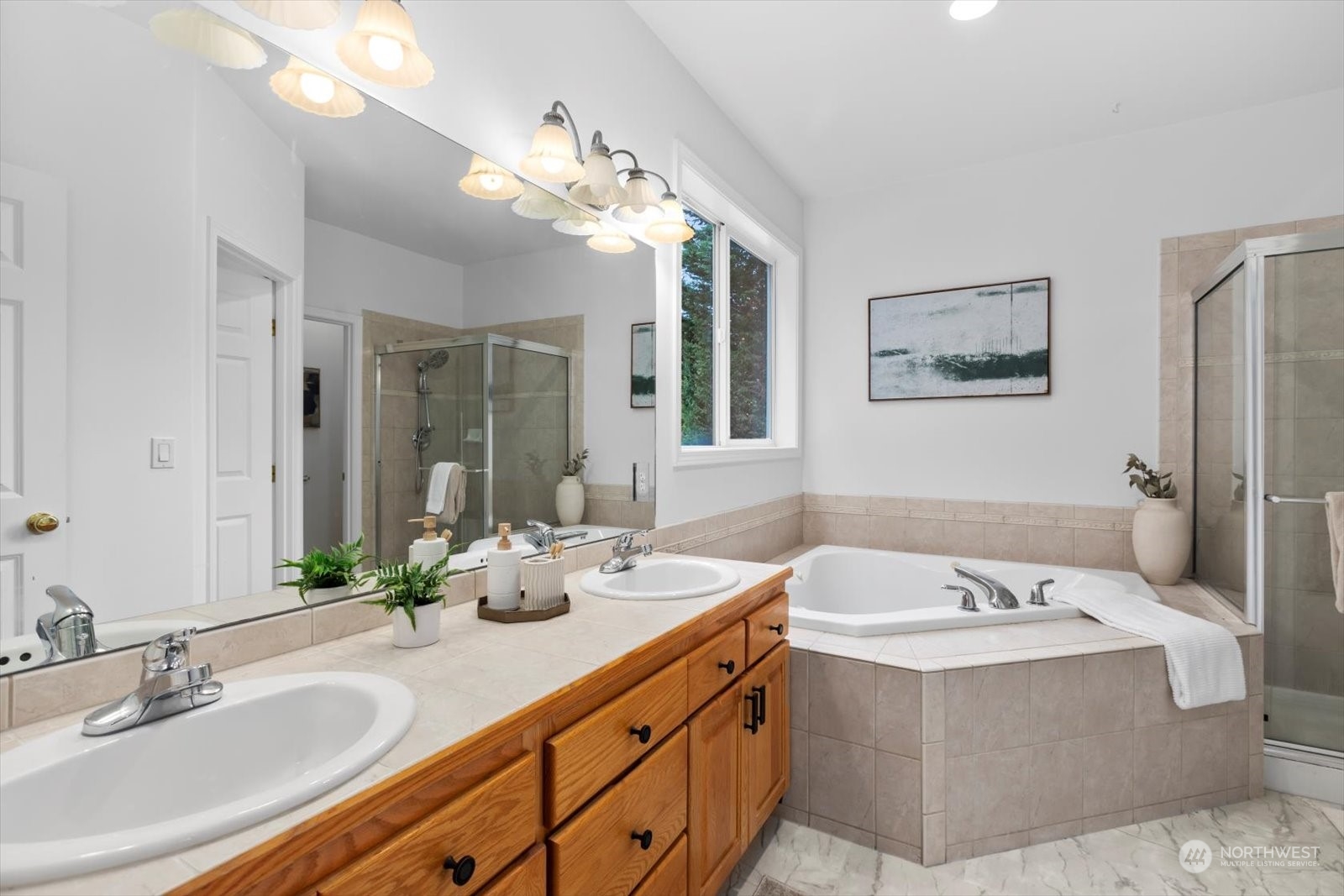 22920 53rd Avenue Southeast Bothell, WA 98021 - Photo 21 of 40 a bathroom with a tub a double vanity sink and a mirror