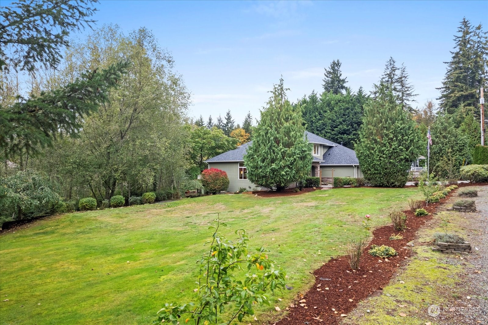 22920 53rd Avenue Southeast Bothell, WA 98021 - Photo 36 of 40 a tall yellow house with a big yard and large trees
