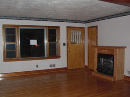 4644 Elva Road Northwest Roanoke, VA 24017 - Photo 2 of 9 a view of an empty room with wooden floor and a fireplace