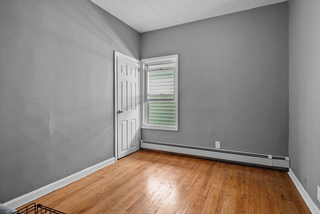 32 Quequechan Street Fall River, MA 02723 - Photo 12 of 34 an empty room with wooden floor and windows