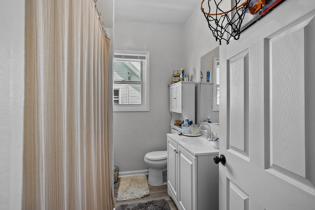32 Quequechan Street Fall River, MA 02723 - Photo 13 of 34 a bathroom with a toilet sink and mirror