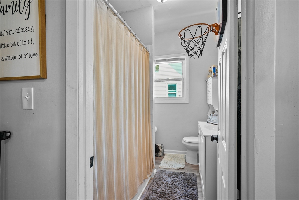 32 Quequechan Street Fall River, MA 02723 - Photo 14 of 34 a bathroom with a toilet and a shower curtain