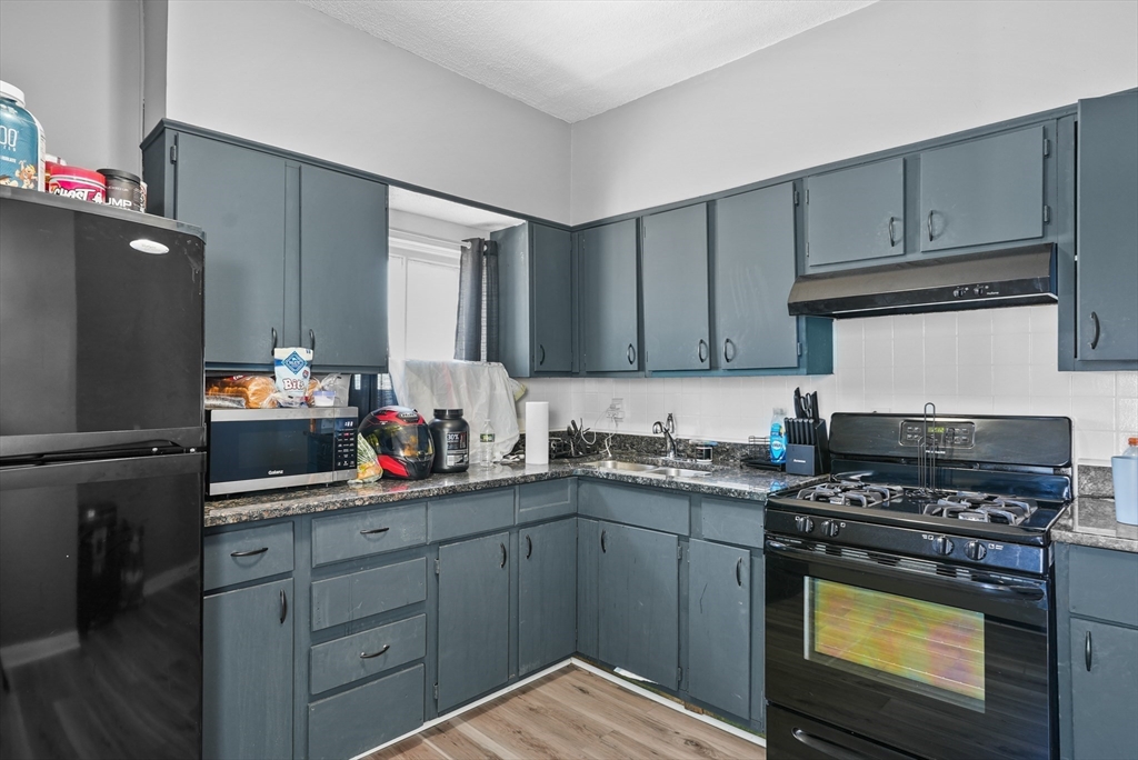 32 Quequechan Street Fall River, MA 02723 - Photo 15 of 34 a kitchen with a sink stove and cabinets