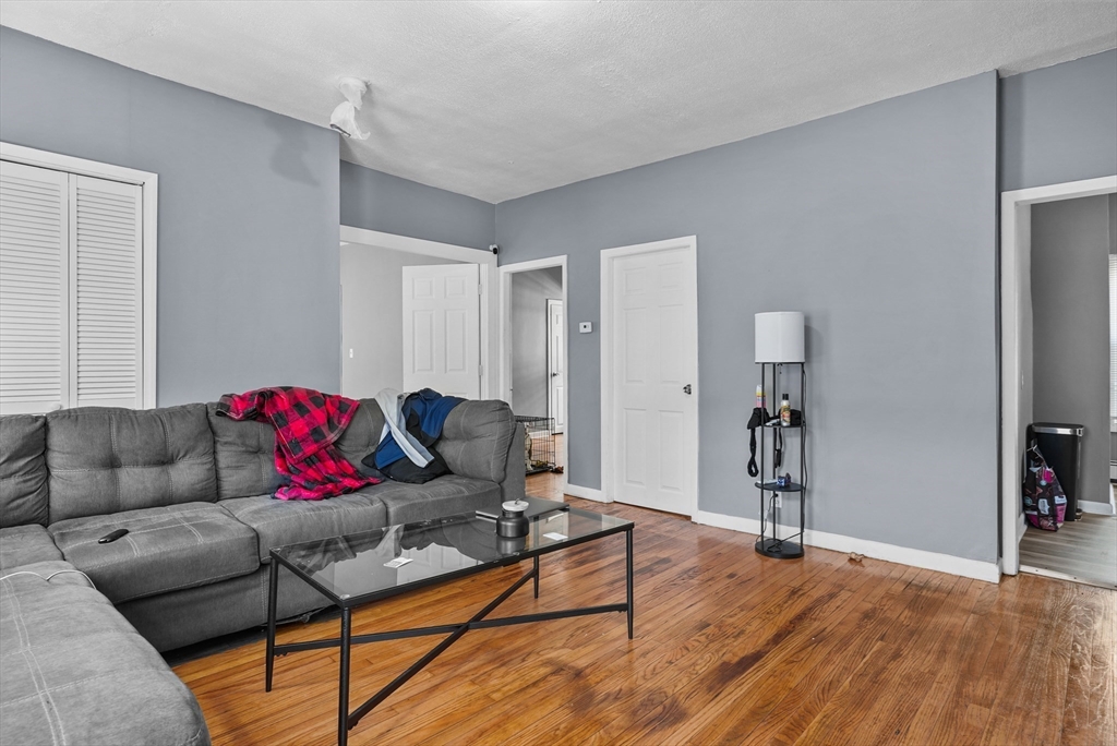 32 Quequechan Street Fall River, MA 02723 - Photo 19 of 34 a living room with furniture and a wooden floor