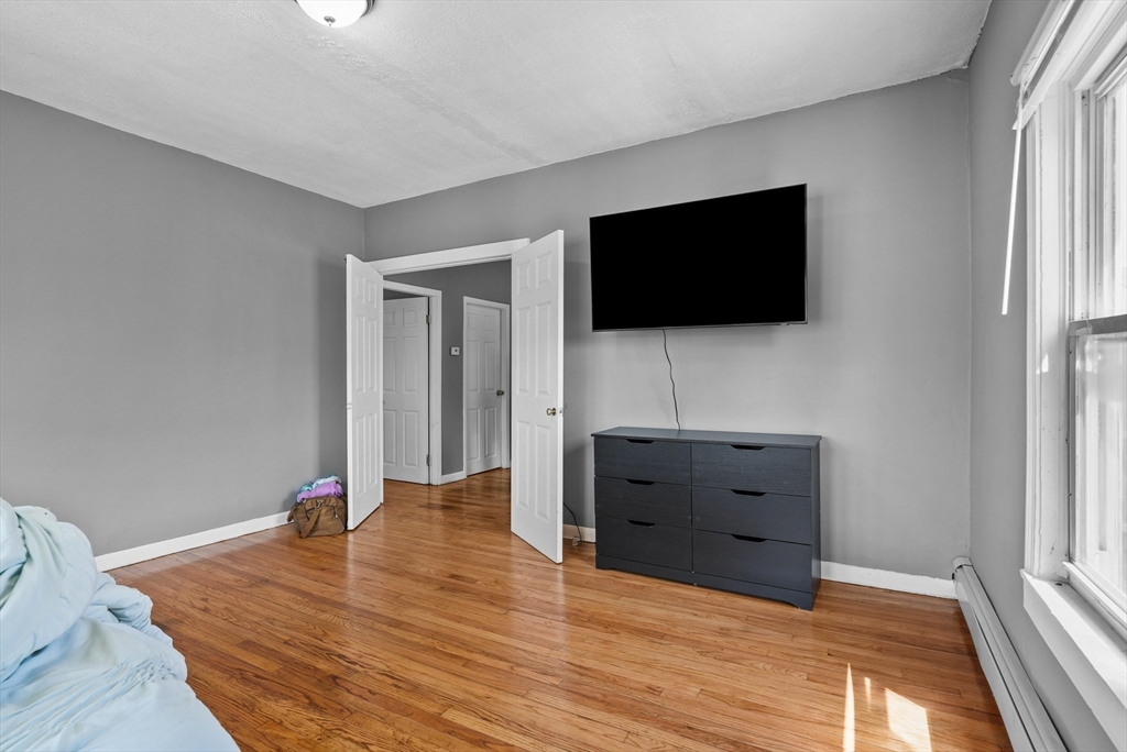 32 Quequechan Street Fall River, MA 02723 - Photo 22 of 34 a living room with furniture and a flat screen tv